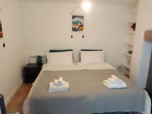 a bedroom with a bed with two towels on it at Beech House 20 minute walk to Airport in Bristol