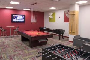 a room with a pool table and a piano at Luxury, Style, and Convenience condo at Crystal City in Arlington