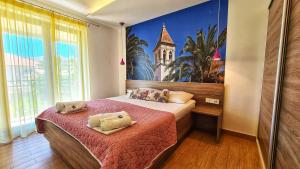 a bedroom with a bed with two pillows on it at Apartments G in Trogir
