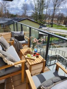 a balcony with chairs and a table on a roof at Alexis apartament Dziwnów in Dziwnów