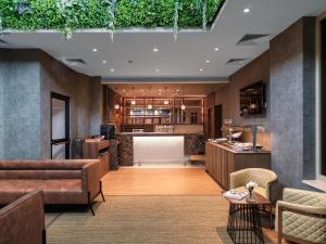 a living room with a couch and a table at Leonardo Boutique Hotel Larnaca in Larnaca