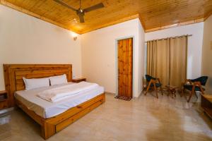 a bedroom with a bed and a table and chairs at Hotel Sarai Bharatgarh in Chandīgarh
