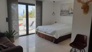 a bedroom with a bed and a balcony at VAR ZENITUDE in Lorgues