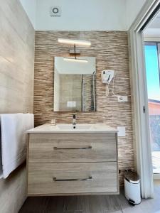 a bathroom with a sink and a mirror at La Dependance ApartHotel Scilla in Scilla
