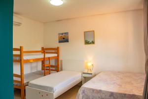 a bedroom with two bunk beds and a ladder at Casa em cond fechado em Barra de Santo Antonio AL in Barra de Santo Antônio +34 photos