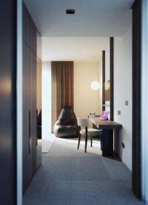 a hallway with a table and a chair in a room at B21 Lifestyle Hotel in Bari