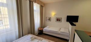 a small room with a bed and a television at Hotel Malá Strana in Prague +40 photos