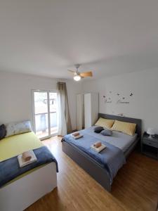 拉布的住宿－Apartman Ana，一间卧室配有两张床和吊扇