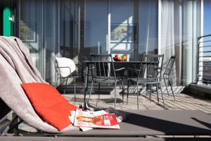a person sitting on a chair on a balcony at Brera Serviced Apartments Munich West in Munich