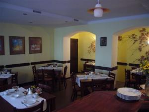 a dining room with tables and chairs in a restaurant at Pension Anna in Český Krumlov