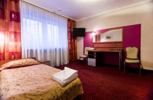 Ένα ή περισσότερα κρεβάτια σε δωμάτιο στο Hotel Orion