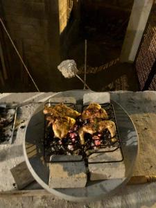 einen Grill mit etwas Essen darüber in der Unterkunft Mini Hostal Cultural de Mazatlán in Mazatlán