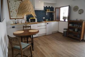 a kitchen with a table and chairs and a microwave at La Pecera Altea in Altea