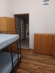 a room with a bunk bed and a dresser and a closet at Fajne Mieszkanko z klimą in Gołdap