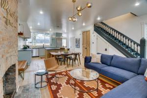 a living room with a blue couch and a table at Indiana Vacation Rental Walk to Madison Main St! in Madison