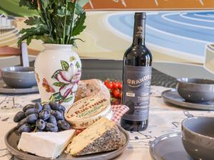 a bottle of wine and a plate of cheese and grapes at Prestella in Filey +25 photos