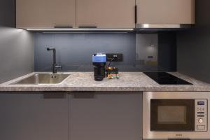A kitchen or kitchenette at Zalo Urban Living Spaces