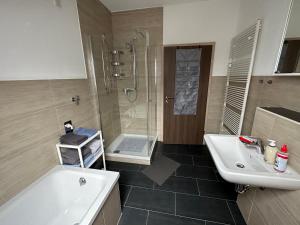 a bathroom with a tub and a sink and a shower at SCHÖNE AUSSICHT in Kleinrechtenbach