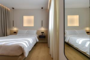 A bed or beds in a room at Zalo Urban Living Spaces