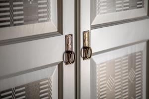 a pair of door handles on a white door at Agriturismo Casa Marmida in Pardu Atzei