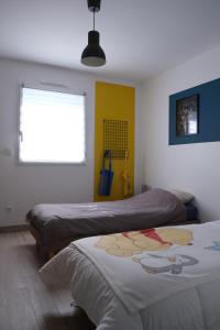 a bedroom with two beds and a window at Home Family Cinema in Seclin