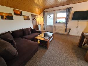a living room with a couch and a table at Ferienwohnung mit Pool in Nordleda
