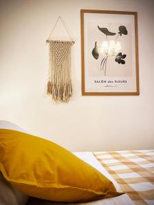 a bedroom with a yellow pillow and a picture on the wall at Casa Micca - Cielo Terra in San Benedetto del Tronto