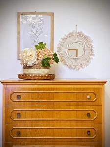 a dresser with a mirror and a vase on top of it at Casa Micca - Cielo Terra in San Benedetto del Tronto