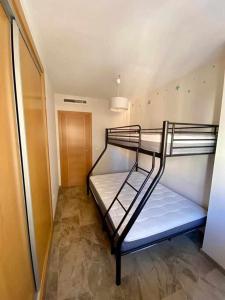 a bunk bed room with two bunk beds in it at Frente a Puerto Azahar 2 in Grao de Castellón