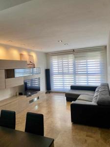 a large living room with a couch and a table at Frente a Puerto Azahar 2 in Grao de Castellón