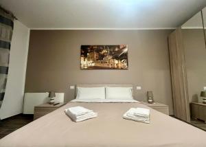 um quarto com uma cama grande com duas toalhas em Sweet Home 051 em Bolonha
