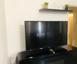 a large flat screen tv sitting on a black entertainment center at Week-end Porte de Clichy in Clichy