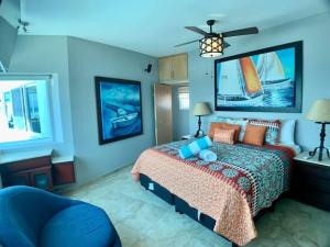 a bedroom with a bed and a blue wall at Condos by Malecon I Breathtaking Ocean View in La Paz +102 photos