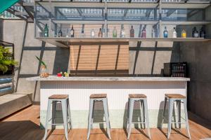 a bar with three stools in front of it at Royal Regency Palace Hotel in Rio de Janeiro