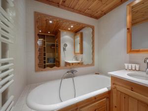 a white bathroom with a tub and a sink at Grand appartement à Val-d'Isère : 4 pièces, 95m², 7 pers, balcons, parking, exposé Sud-Est - FR-1-567-4 in Val dʼIsère