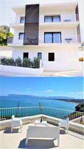 a white building with a view of the ocean at SOL Y MAR Camere e Appartamenti in Castellammare del Golfo