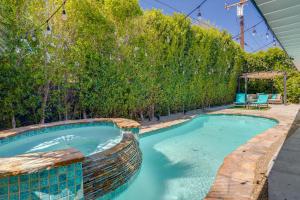 a swimming pool in a backyard with a fence at Sunny Palm Springs Home with Private Pool and Patio! in Palm Springs