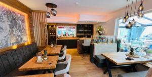 a restaurant with tables and chairs and a bar at WEiNECK Altenahr in Altenahr