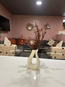 a white vase with flowers in a living room at Bigg Market Apartments in Newcastle upon Tyne