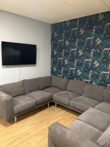 a living room with a couch and a flat screen tv at Bigg Market Apartments in Newcastle upon Tyne