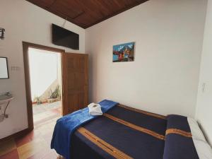 a bedroom with a bed in a room with a window at Anexo By Hotel Maya Ik' in Antigua Guatemala