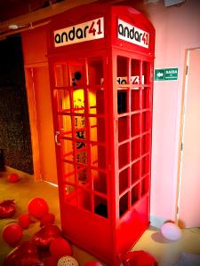 a red phone booth in a room with red balls at Experience 41 in Sao Paulo