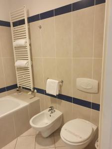 a bathroom with a toilet and a sink at eq hotel in Travagliato +15 photos