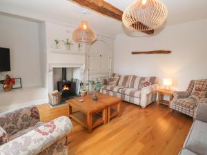 a living room with two couches and a fireplace at The Dower House in Keswick