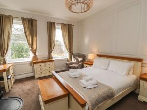 a bedroom with a bed with two towels on it at The Dower House in Keswick