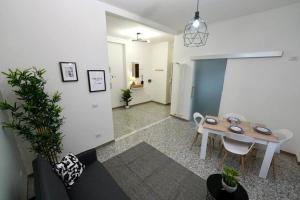 a living room with a table and a couch at Cinecittà Luxury Flat Metro A in Rome