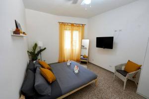a bedroom with a large bed and a television at Cinecittà Luxury Flat Metro A in Rome