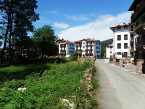 a row of buildings on a street next to a road at Apartamento Rural Elizondo in Elizondo