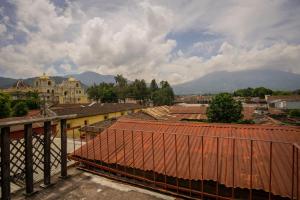 a view of a city with buildings and mountains at Anexo By Hotel Maya Ik' in Antigua Guatemala