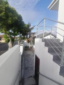 a stair railing on the side of a white building at Mila Lodge 2 in Cape Town